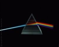 Image d'un faisceau de lumière traversant un prisme pyramidal transparent, la lumière en ressort décomposée de l'autre côté, sur un fond très noir